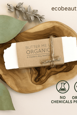Butter Me Up Organics handmade soap bar with kraft paper label and jute twine, resting on an olive wood tray with dried eucalyptus leaves – eco-friendly presentation, ecobeaut.com