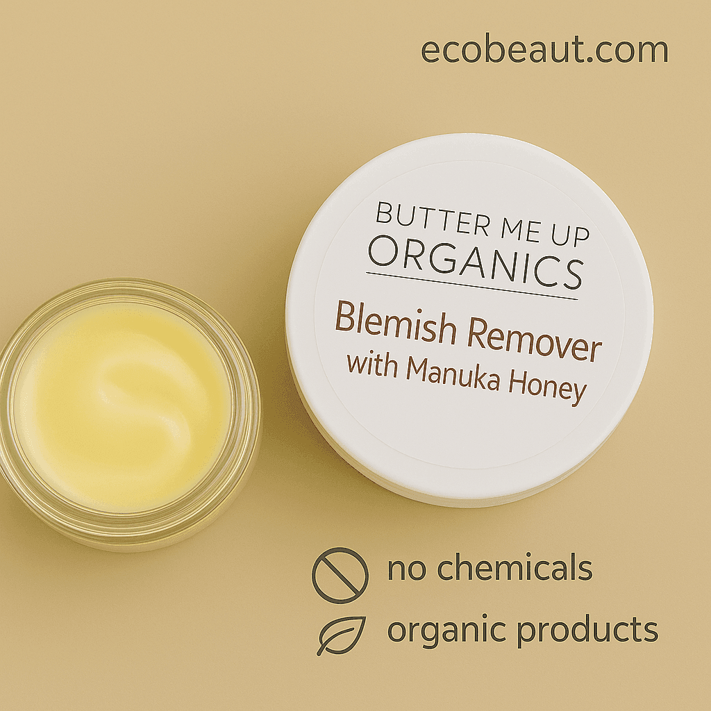 Close-up of Butter Me Up™ Organics Blemish Remover with Manuka Honey on a beige background, featuring an open jar of yellow cream, product lid with branding, and eco-friendly labels 'ecobeaut.com', 'no chemicals', and 'organic products