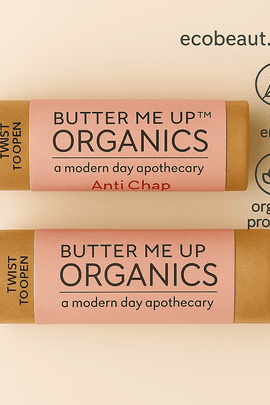 Close-up of Butter Me Up™ Organics lip balm on a neutral background with ecobeaut.com, no chemicals, and organic products labels in the top right corner, showcasing eco-friendly packaging and natural ingredients
