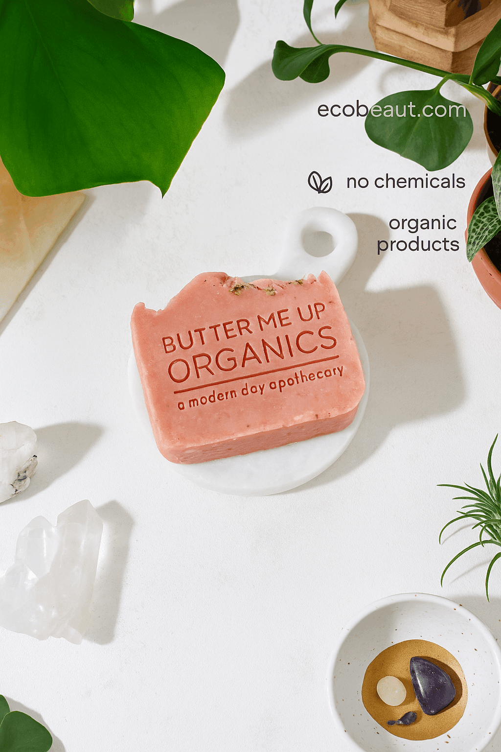 Close-up of Butter Me Up Organics pink soap bar with embossed label and herbal topping, featuring ecobeaut.com, no chemicals and organic products – handmade natural soap USA