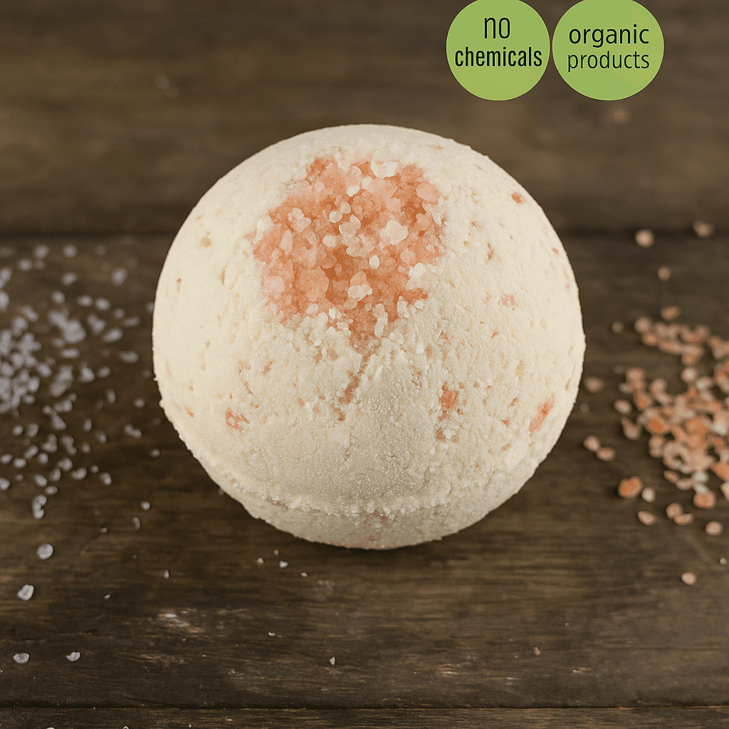 Bath bomb with pink specks on a wooden surface, labeled as organic product.