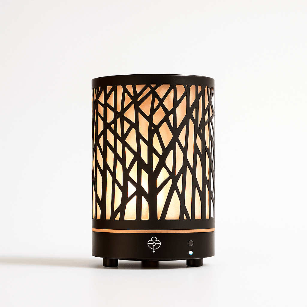 Close-up of essential oil diffuser with tree-branch cutout design glowing softly, displayed on a white background with ecobeaut.com in the corner