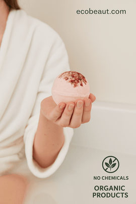 Close-up of pink bath bomb with floral topping in a woven dish on beige background, labeled no chemicals and organic products — ecobeaut.com