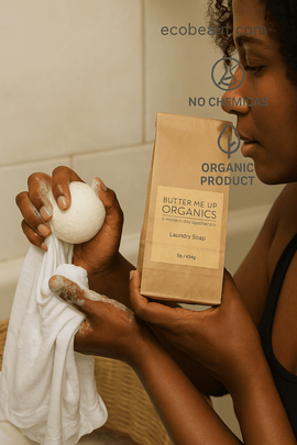 Dark-skinned woman using Butter Me Up Organics laundry soap in a natural laundry room, eco-friendly and chemical-free – ecobeaut.com