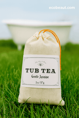 EcoBeaut.com Tub Tea Gentle Jasmine — natural bath tea in eco-friendly linen bag with orange drawstring, displayed on vibrant green grass with a white bathtub in the background, highlighting organic spa and relaxation products in the USA.