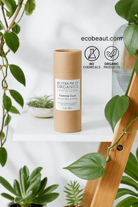 "Femme Dust powder in kraft tube on white shelf with plants, eco labels, and ecobeaut.com branding in the top right corner."