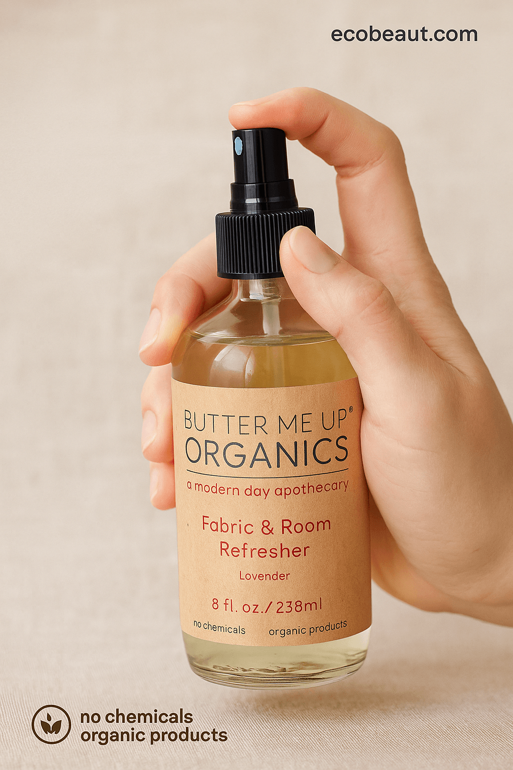 Hand holding Butter Me Up Organics lavender room spray with ecobeaut.com text and clean beige background – organic product used for natural air freshening