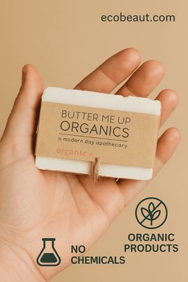 Hand holding Butter Me Up Organics natural soap wrapped in kraft paper and twine, labeled no chemicals and organic products – sustainable skincare, ecobeaut.com