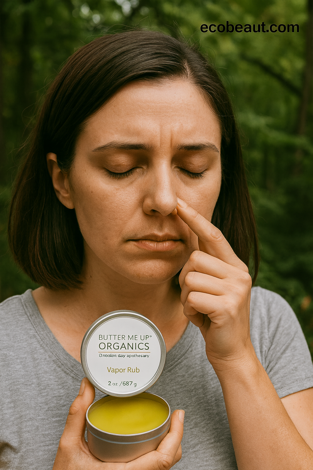 Woman holding a container of 'Butter Me Up Organics' vapor rub outdoors.
