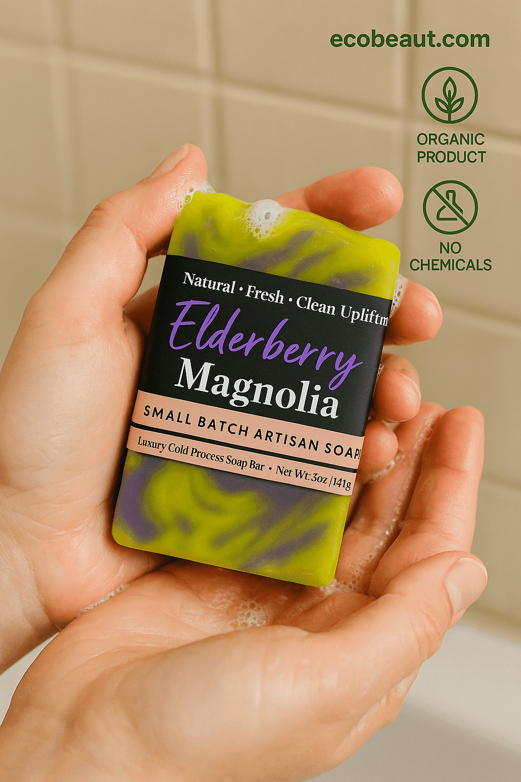 Hands of a person using Elderberry Magnolia artisan soap with foam, featuring ecobeaut.com, “ORGANIC PRODUCT” and “NO CHEMICALS” icons in the top right corner.
