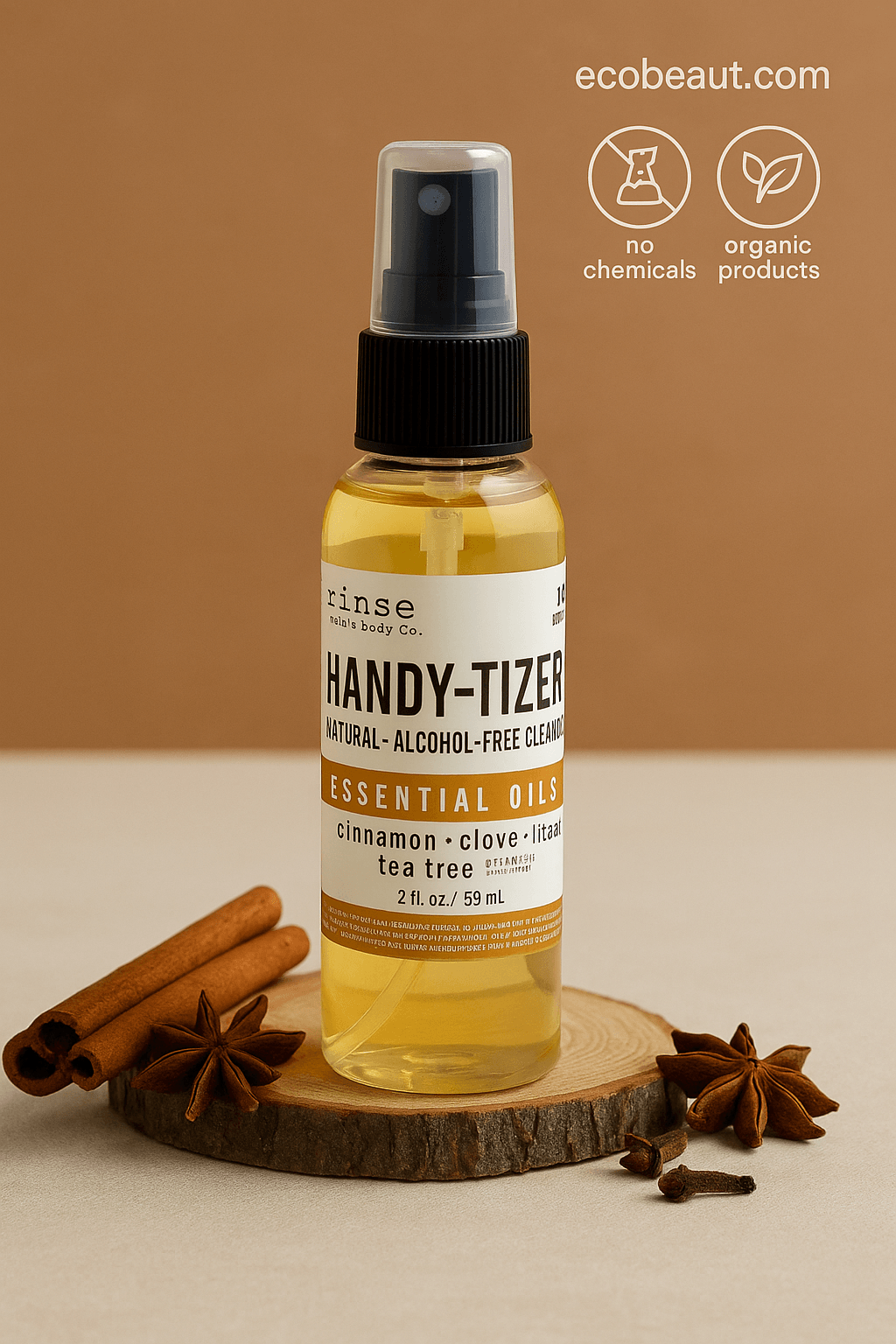 Handy-Tizer alcohol-free cleansing spray in a clear cylindrical bottle with black nozzle, placed on a rustic wooden surface surrounded by star anise and cloves, with eco-friendly labels and ecobeaut.com displayed in the top right corner