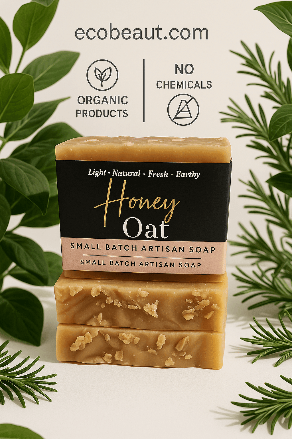 Honey Oat artisan soap bars stacked among lush green leaves, with oat flakes visible, featuring ecobeaut.com, “NO CHEMICALS,” and “ORGANIC PRODUCTS” icons in the top center.





