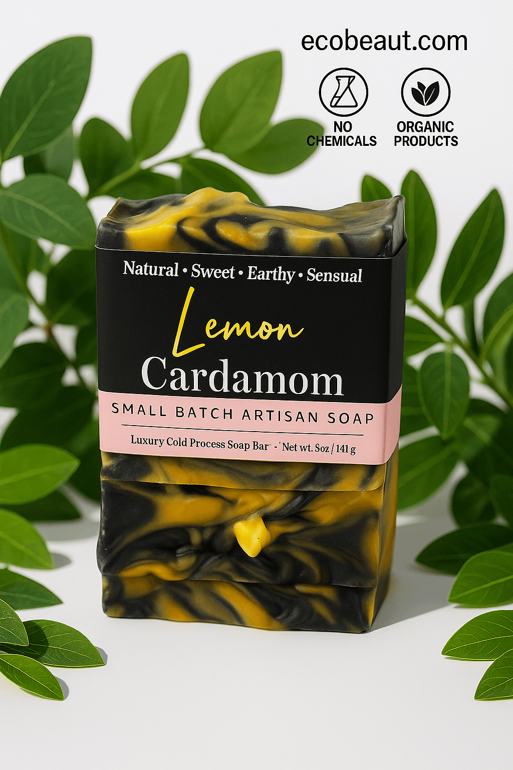 Lemon Cardamom Small Batch Artisan Soap bar by ecobeaut.com placed among fresh green leaves with “NO CHEMICALS” and “ORGANIC PRODUCTS” icons in the upper right corner.