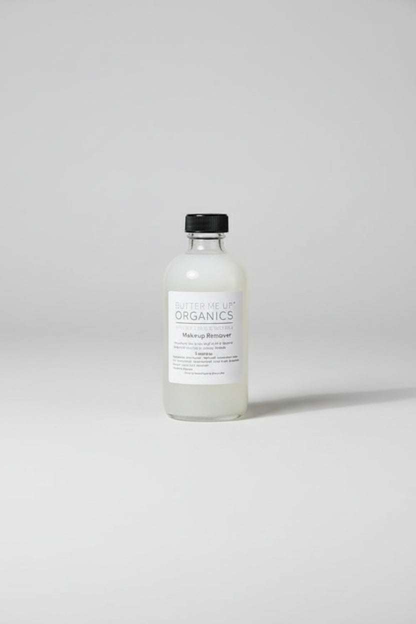 Bottle of 'Organics' product on a wooden surface with plants in the background