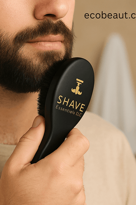 Man grooming beard using black SHAVE Essentials boar bristle brush with ergonomic handle and gold branding — ecobeaut.com