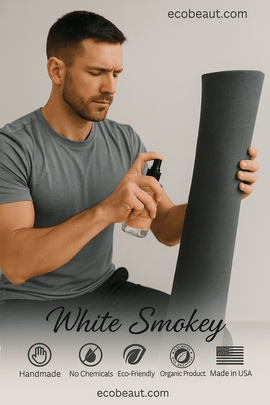 Man holding a black spray bottle and a black mat with 'White Smokey' branding and product details.
