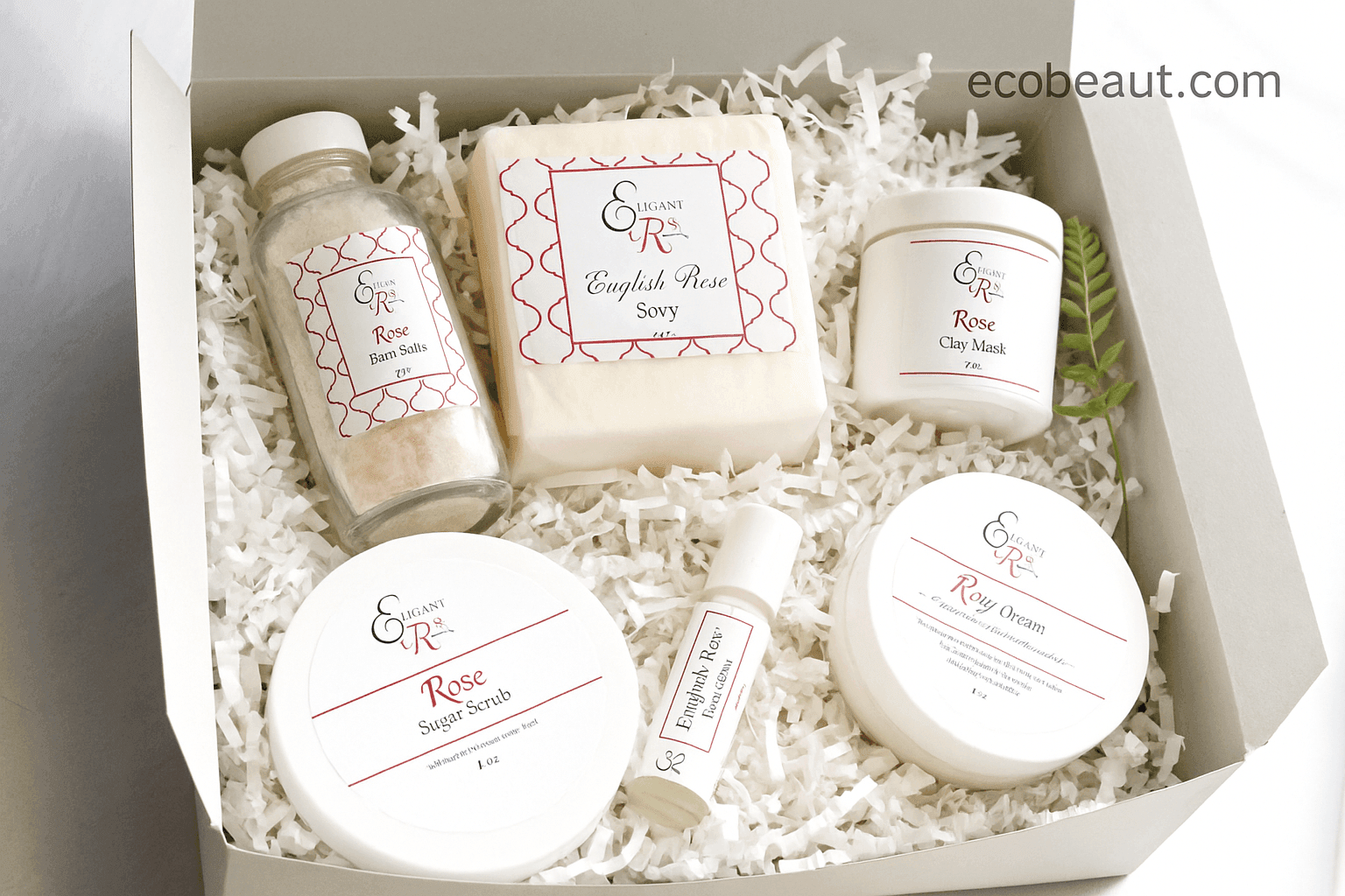 Open gray gift box featuring Elegant Rose skincare products including English Rose soap, bath salts, clay mask, scrub, and cream, neatly arranged in white shredded paper with ecobeaut.com in the top right corner.