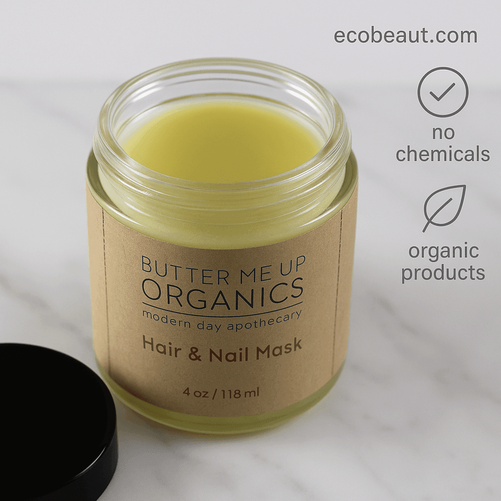 Open jar of Butter Me Up Organics Hair & Nail Mask placed on a white marble surface, with the label clearly visible. In the top right corner, the website "ecobeaut.com" is displayed alongside icons reading "no chemicals" and "organic products."
