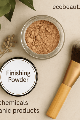 Open jar of loose finishing powder on a textured stone surface with a makeup brush nearby, surrounded by eucalyptus leaves and dried botanicals. Text “ecobeaut.com” is in the top right corner; “no chemicals” and “organic products” appear at the bottom.