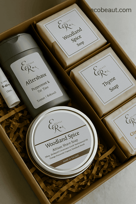 Open kraft gift box with Elegant Rose Woodland Spice grooming products including soap bars, aftershave, and shave soap, neatly arranged on brown filler paper with ecobeaut.com in the top right corner.
