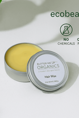 Butter Me Up Organics hair wax container with green leaves on a light background, featuring ecobeaut.com branding.