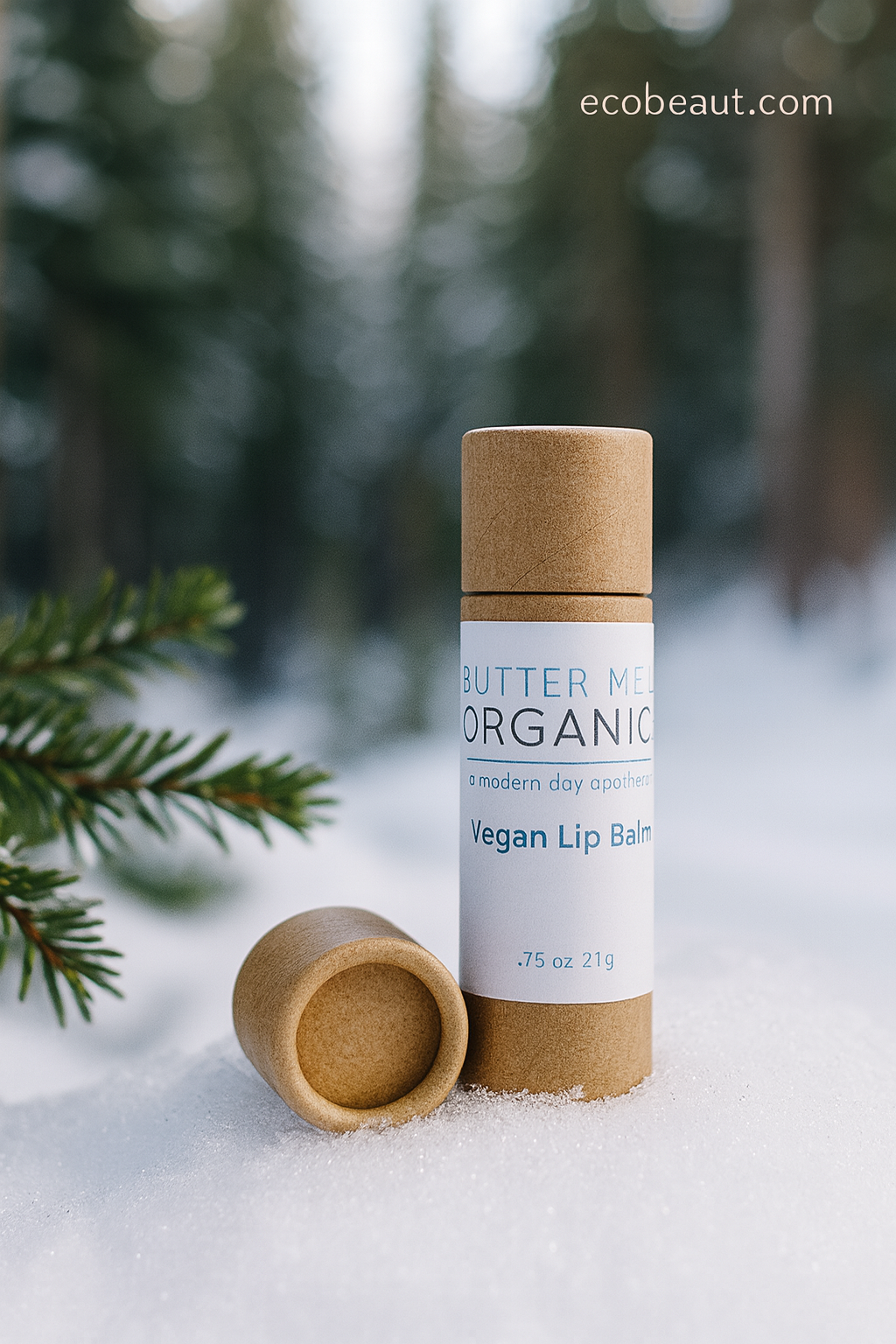 Butter Me Organic lip balm in a natural setting with trees and snow.