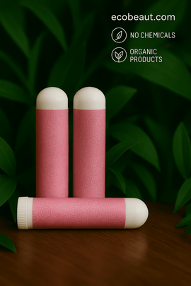Three pink aromatherapy inhalers with white caps on a wooden surface, green leaves in the background, and “ecobeaut.com” with eco-friendly icons in the top right corner.