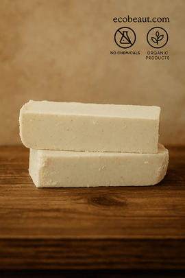 Two handmade organic soap bars from ecobeaut.com on a wooden surface, featuring “NO CHEMICALS” and “ORGANIC PRODUCTS” icons in the top right corner.



