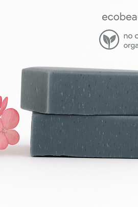 Two stacked charcoal soap bars with pink flowers – detoxifying handmade soap with no chemicals and organic ingredients, ecoBeaut.com