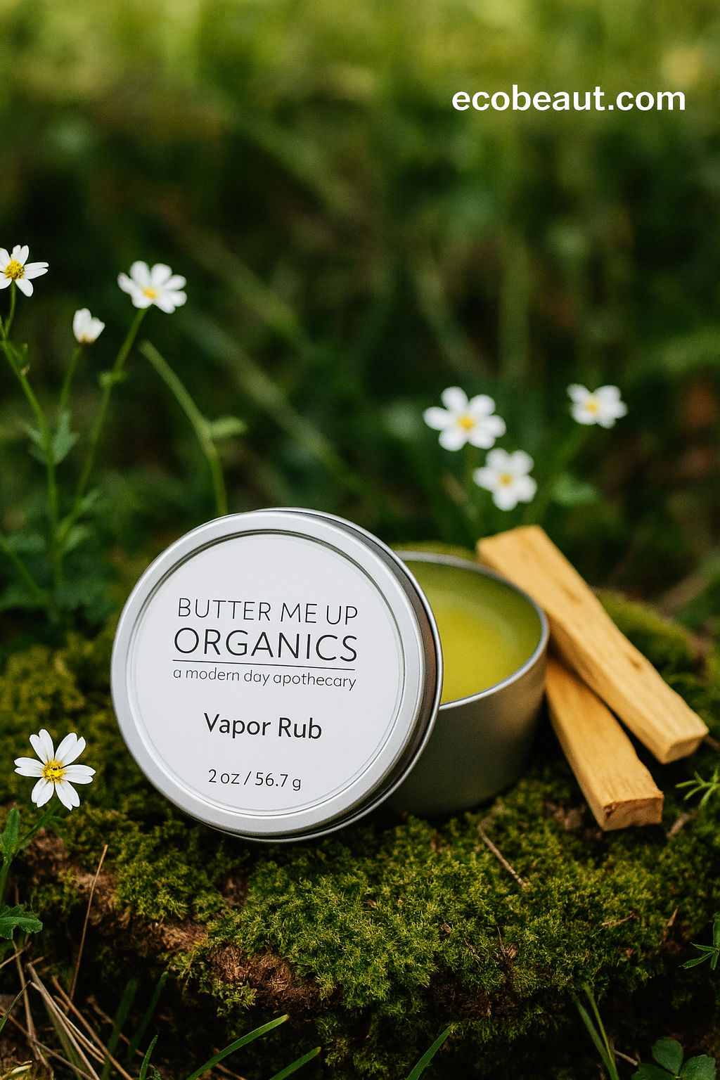 Butter Me Up Organics Vapor Rub tin on a grassy background with flowers