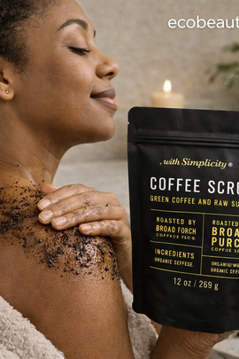 Woman applying coffee scrub to her shoulder with a package labeled 'Coffee Scrub' in a bathroom setting.