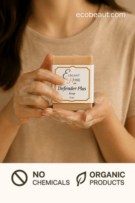 Woman with clean hands holding lathered Defender Plus soap bar by Elegant Rose, labeled with no chemicals and organic product icons, ecobeaut.com in top right corner.




