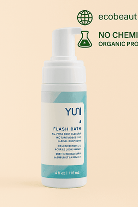 YUNI Flash Bath No-Rinse Body Cleanser standing upright on a beige background with eco-friendly icons. Labeled as organic and chemical-free with ecobeaut.com branding in the top corner.