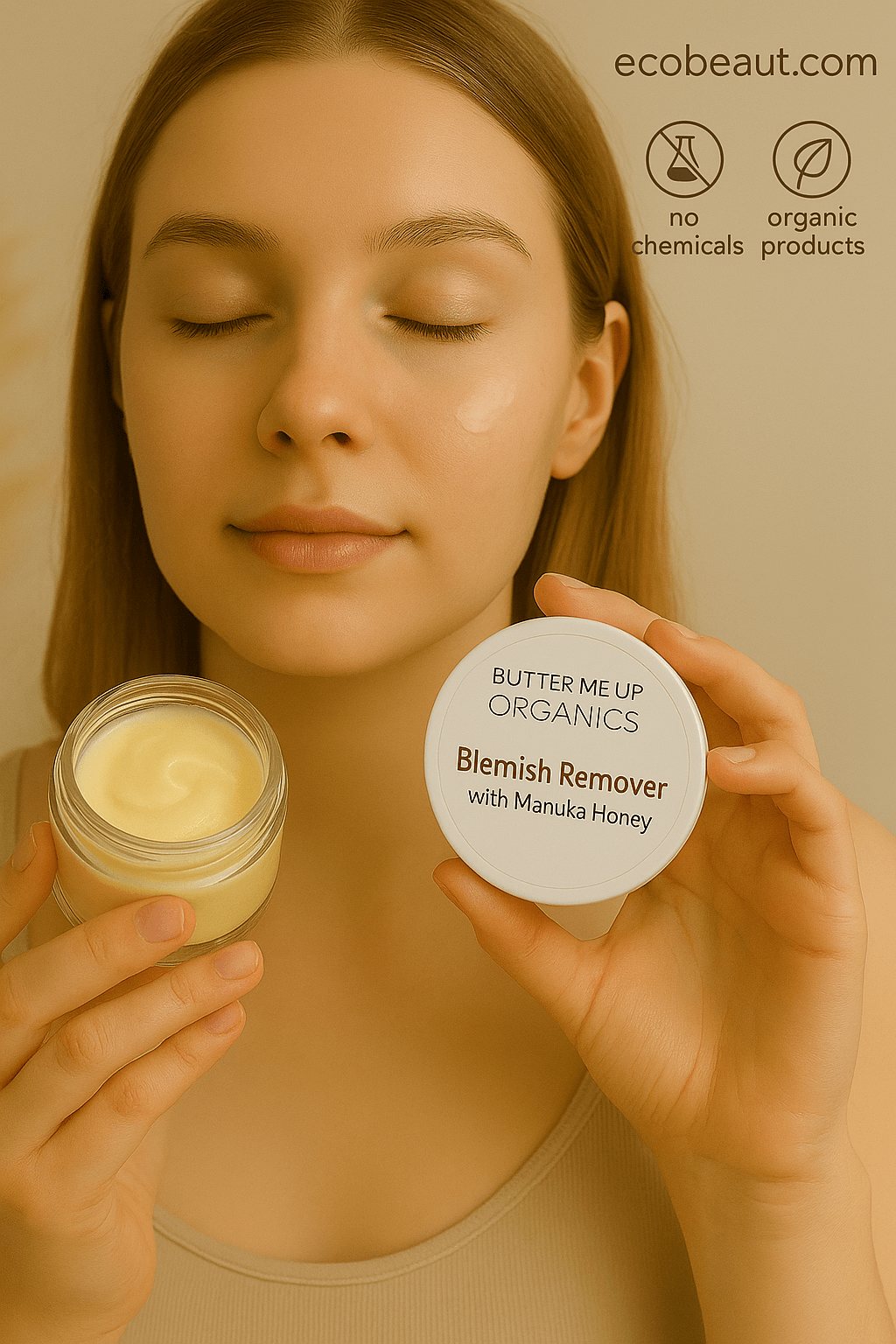 Young woman applying Butter Me Up™ Organics Blemish Remover with Manuka Honey to her cheek, holding the product jar and lid, with eco-friendly labels 'ecobeaut.com', 'no chemicals', and 'organic products' in the top right corner on a neutral background
