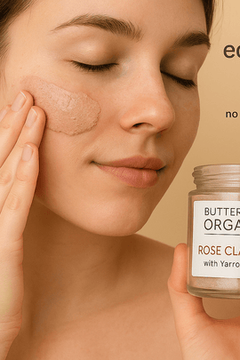 Young woman applying Butter Me Up Organics Rose Clay Mask to her cheek while holding the jar, with eco-friendly icons and ecobeaut.com in the top right corner