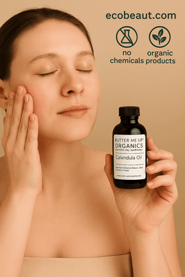 Young woman with light skin applying Butter Me Up Organics Calendula Oil to her face, holding a dark amber bottle, with ecobeaut.com and eco-label icons for no chemicals and organic products in the top right corner against a neutral beige background








