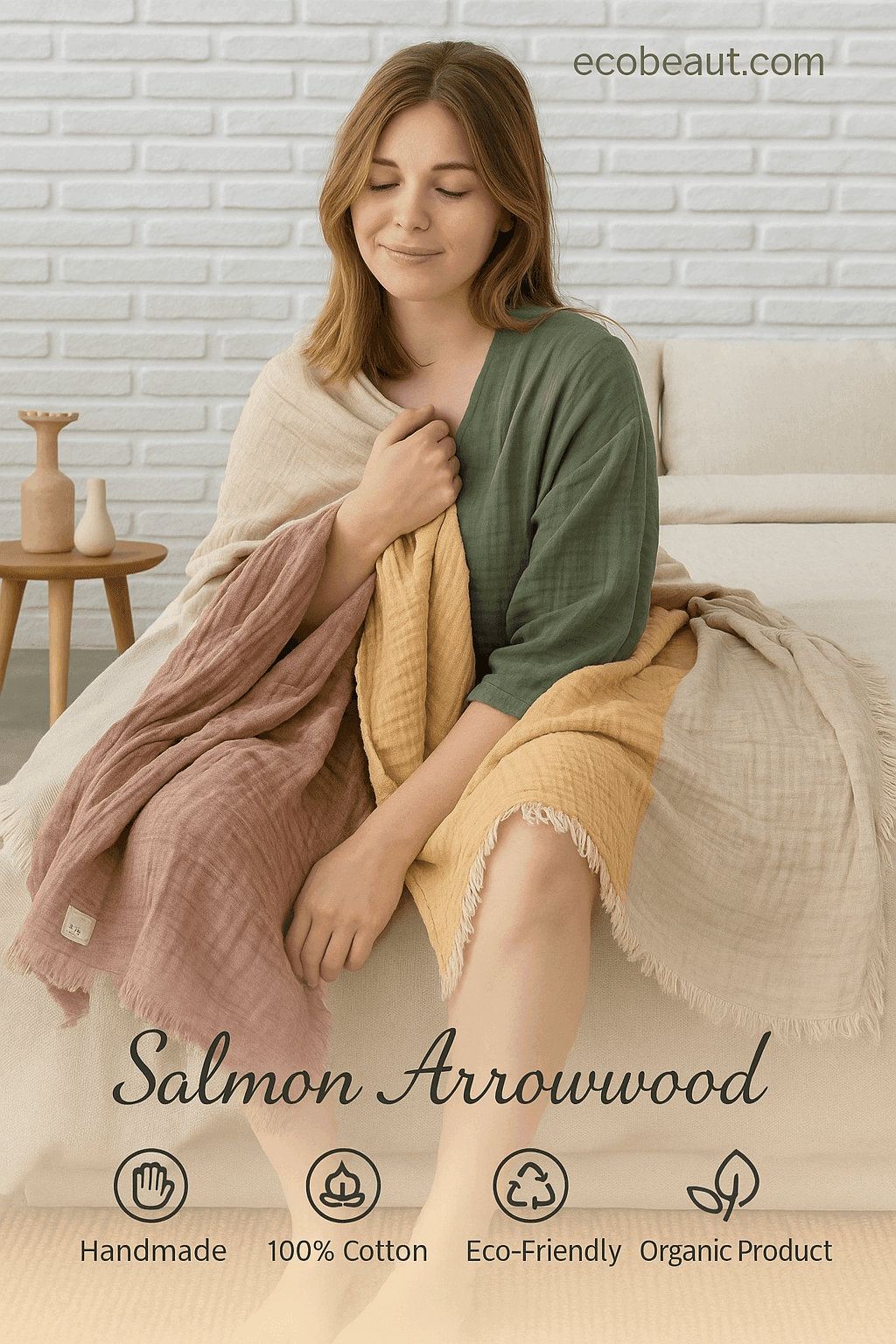 Young woman with light skin relaxing on a couch wrapped in an eco-friendly, handmade Salmon Arrowwood cotton throw blanket in natural tones – organic and 100% cotton.