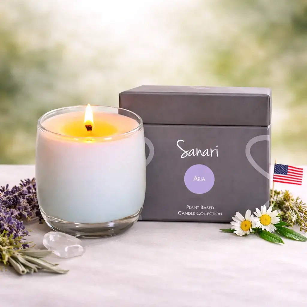 Sanari candle with packaging and flowers on a blurred natural background