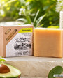 A bar of Miga Natural Co. Goat Milk Soap Bars in the Avocado scent, shown next to its kraft paper packaging box.