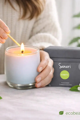 Person lighting a candle with 'Sanari' packaging in the background