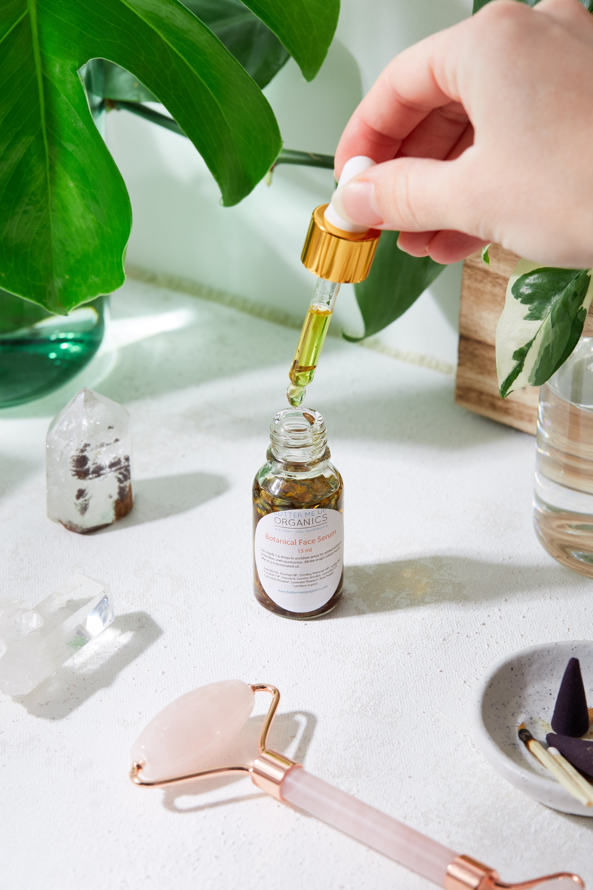 lose-up of amber glass bottle labeled Anti-Aging Youth Serum by Organics, featuring a white dropper and gold collar on a neutral background – ecobeaut.com, no chemicals, organic products