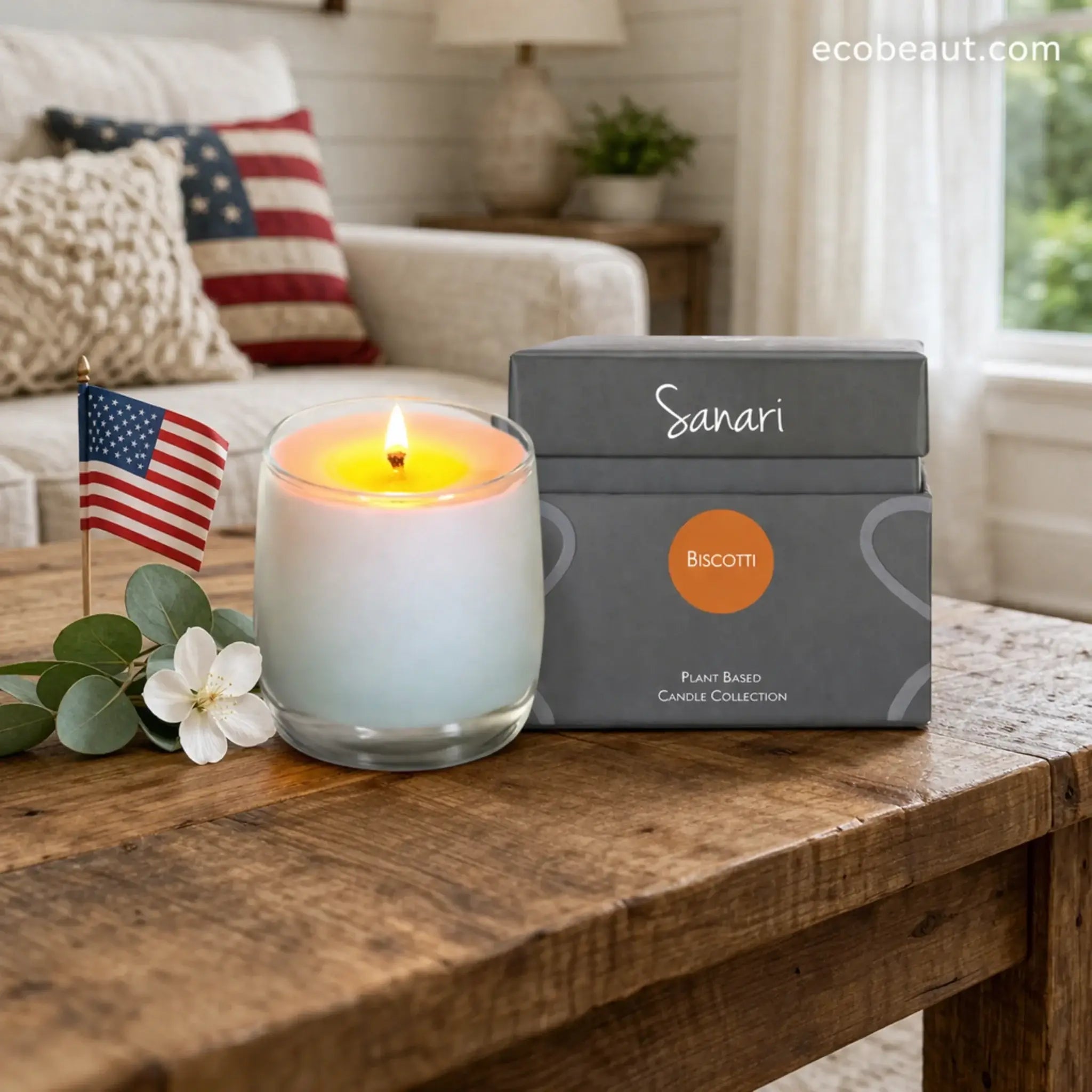 Lit candle in a decorative container next to a gray box labeled 'Sanari' on a wooden surface.