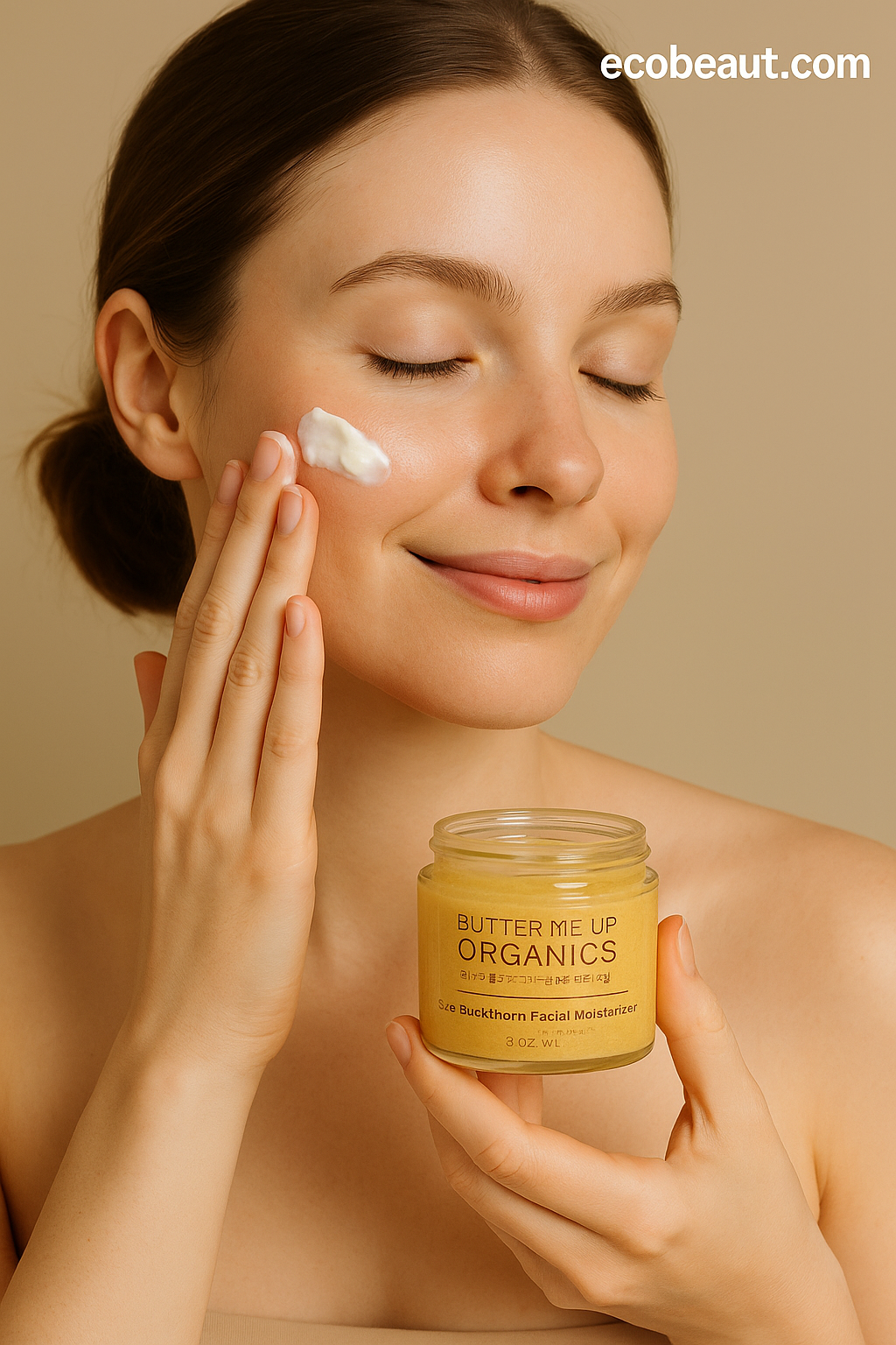 Smiling woman applying Butter Me Up Organics sea buckthorn facial moisturizer to her cheek and holding the jar, gentle natural skincare promotion from ecobeaut.com